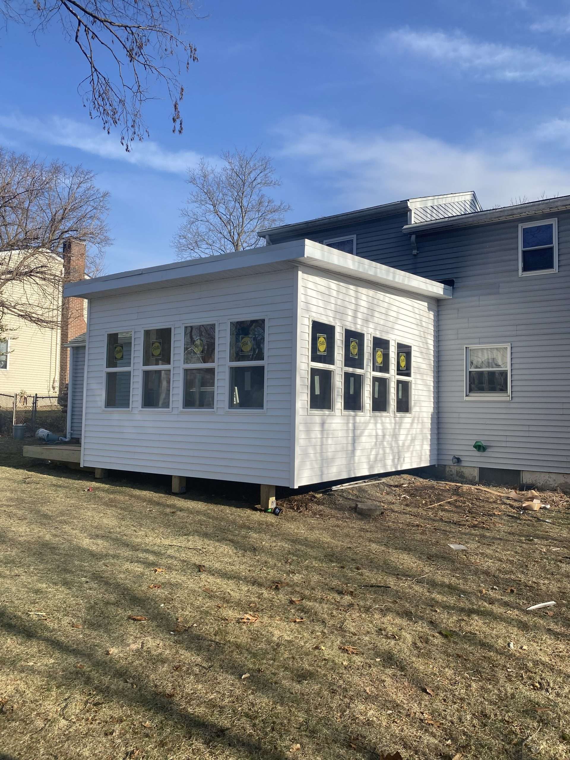 3 season sunroom on the raised wooden deck featuring clear sky view in worcester ma