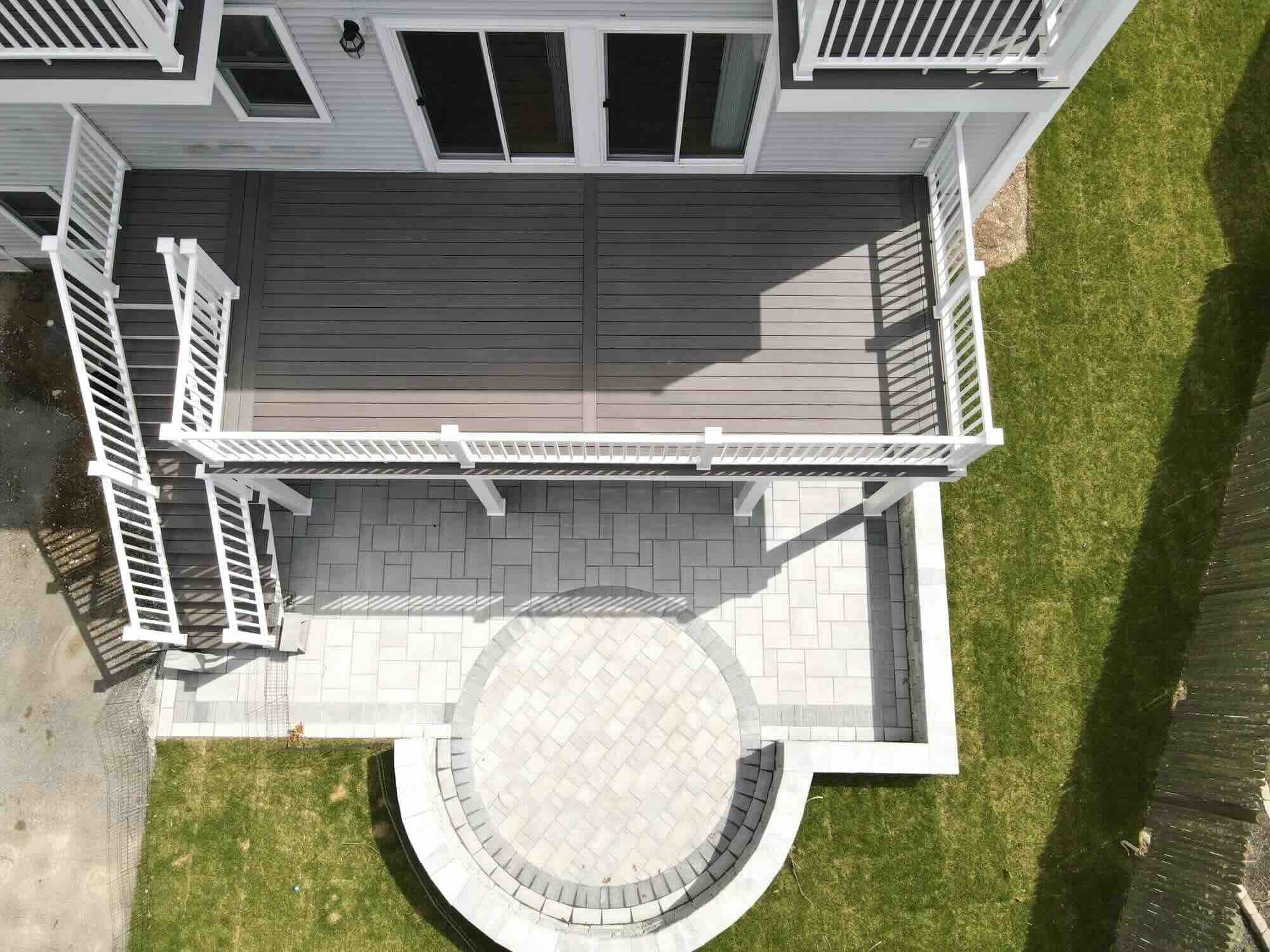 aerial-view-of-the-composite-with-paver-below-and-white-aluminum-railing-with-sliding-glass-doors-in-worcester-ma.jpeg