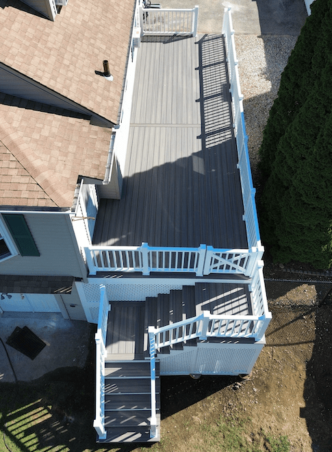 Aerial view of the elevated deck with white skirting and railing with a gate in worcester ma