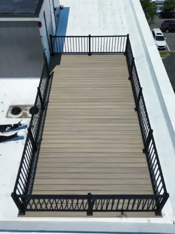 Aerial view of the roof deck wood installation with black railings in worcester ma