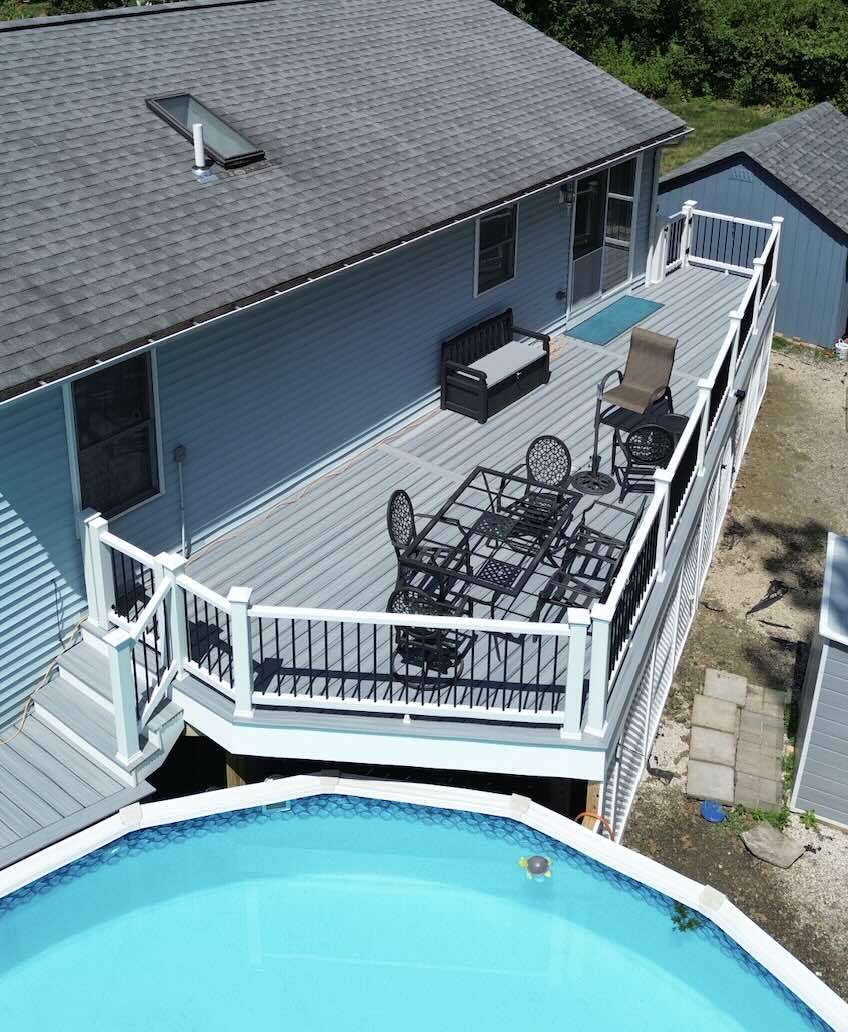 Backyard deck installation with pool and outdoor living spaces in worcester ma