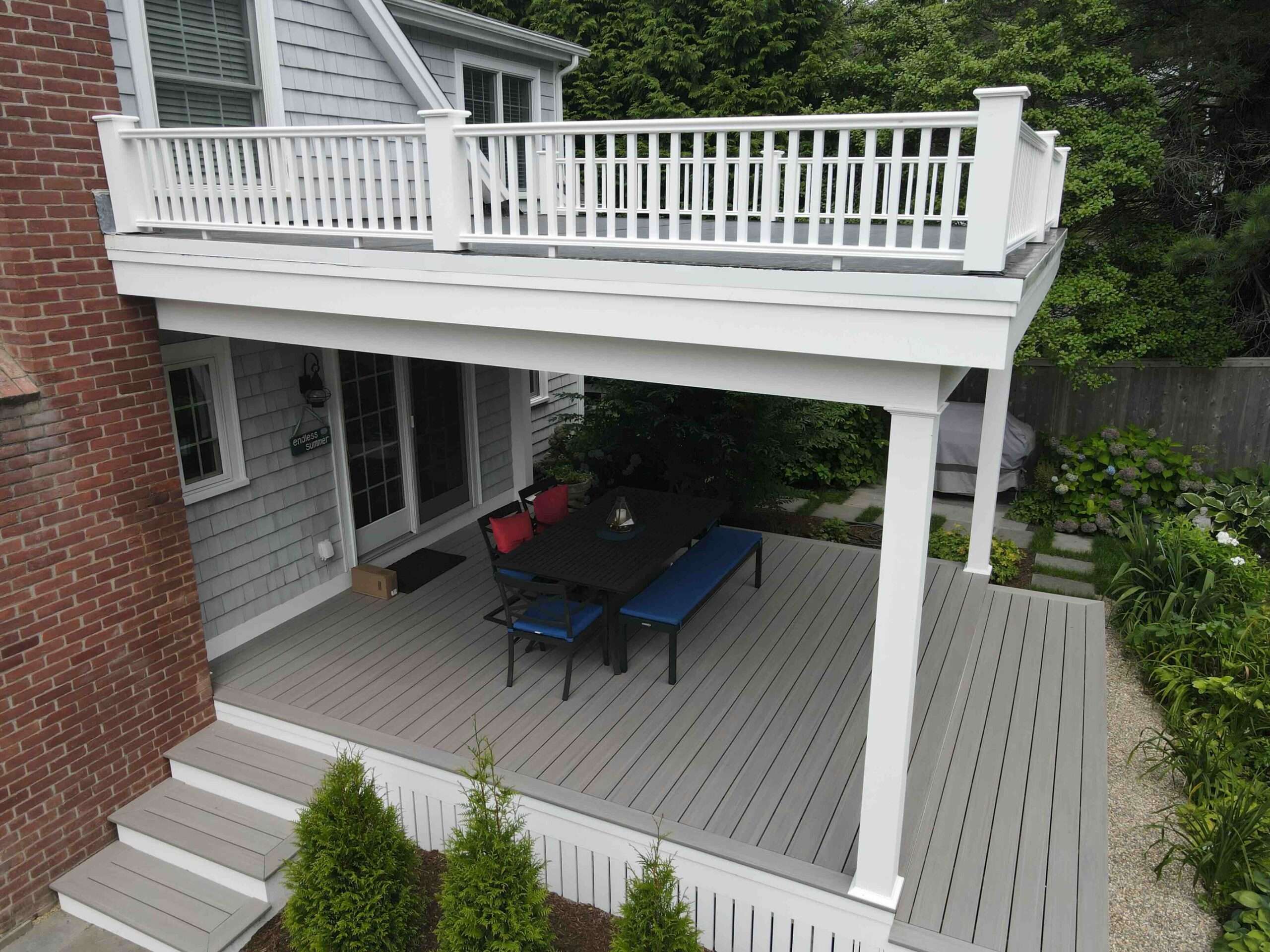 commercial-under-deck-with-white-aluminum-railing-and-outdoor-living-furniture-on-the-under-deck-in-worcester-ma.jpeg