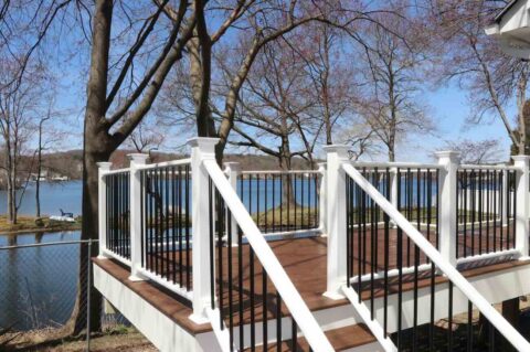 composite-deck-with-vinyl-post-and-aluminum-bars-featuring-trees-and-lake-view-in-worcester-ma.jpg