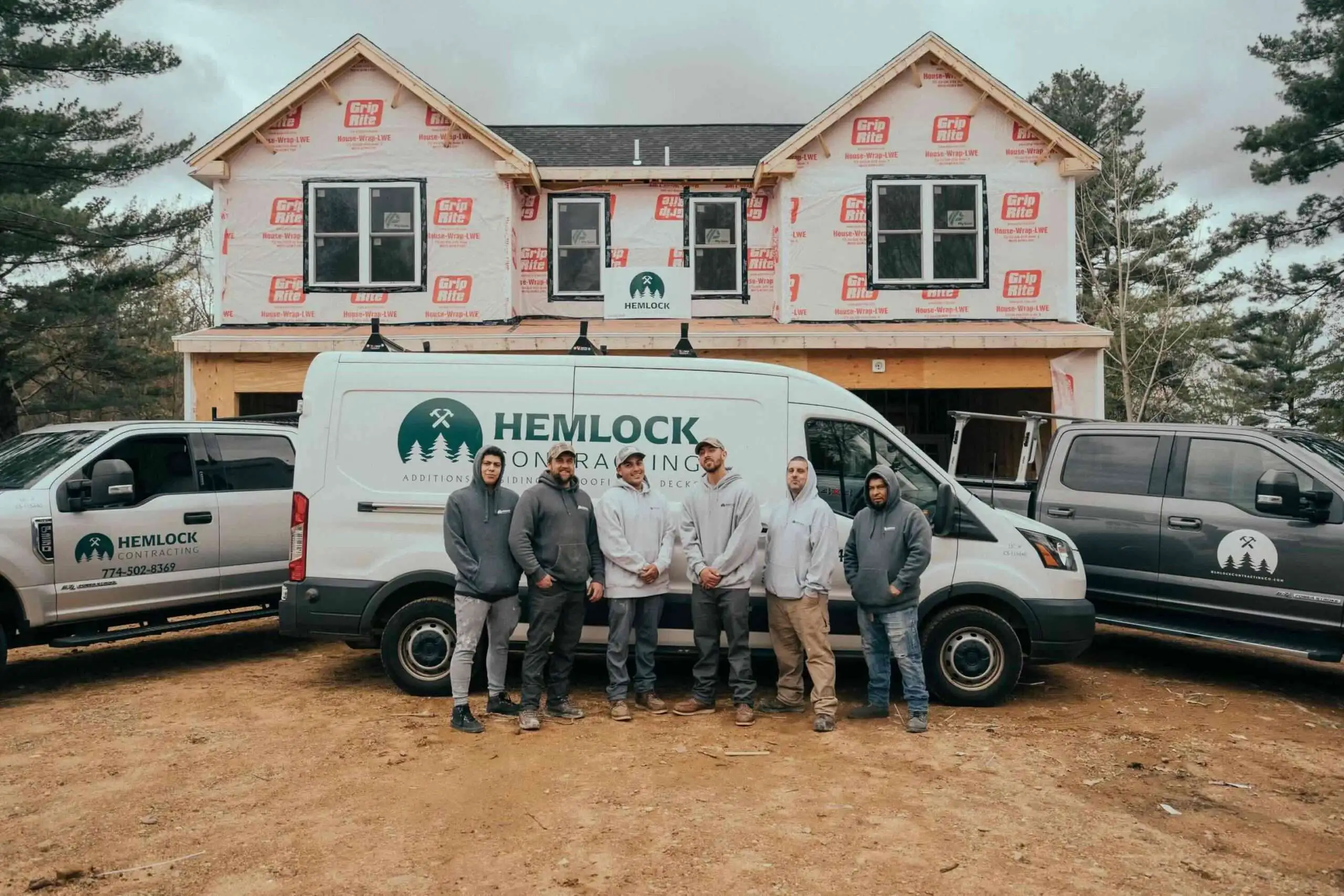 Hemlock contracting team expert posing on the vehicle branded of the hemlock in worcester ma