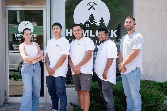 Hemlock contracting team posing in front of their office