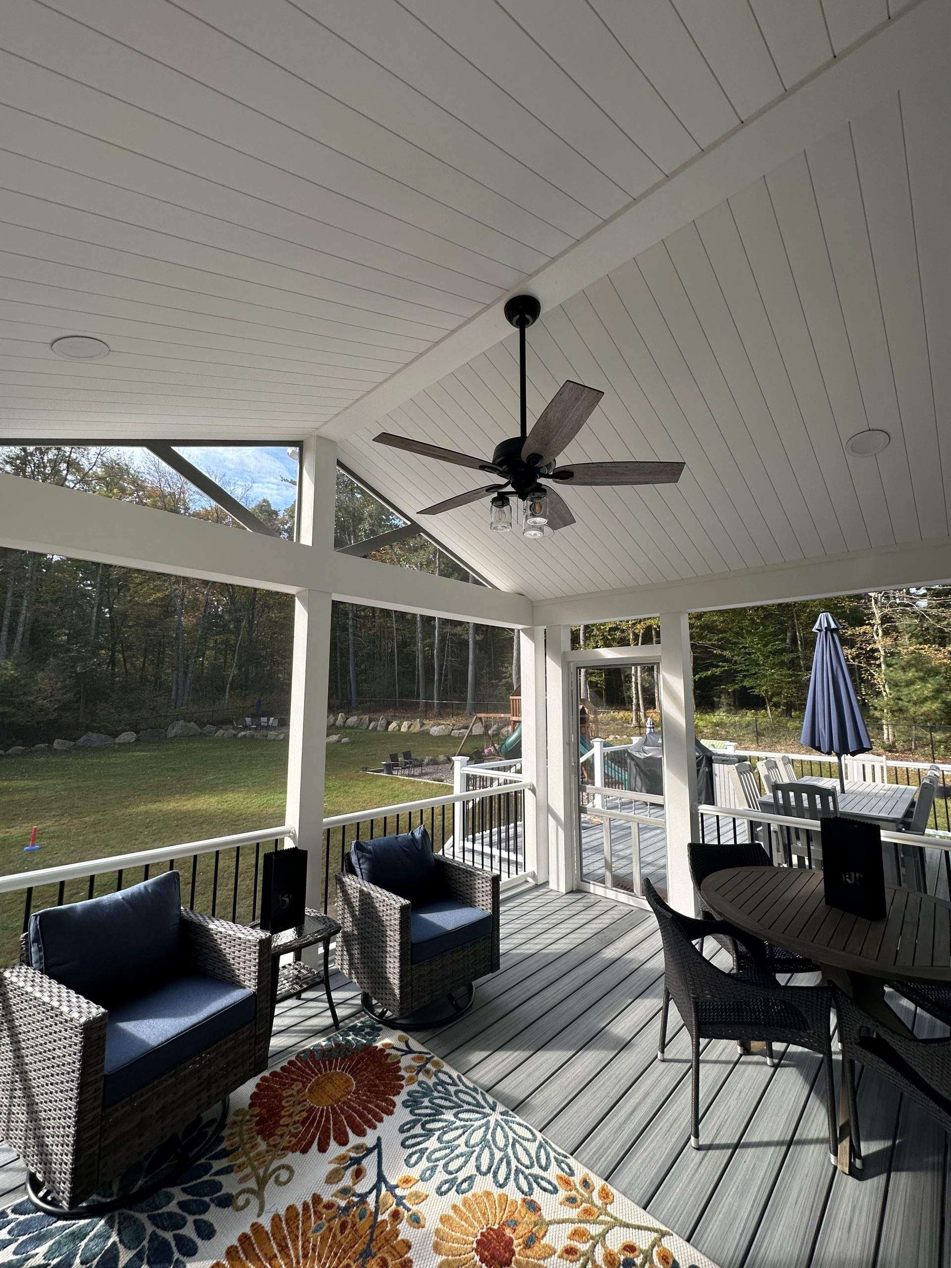Interior of the screened in porches on the pvc deck with outdoor living furniture in worcester ma