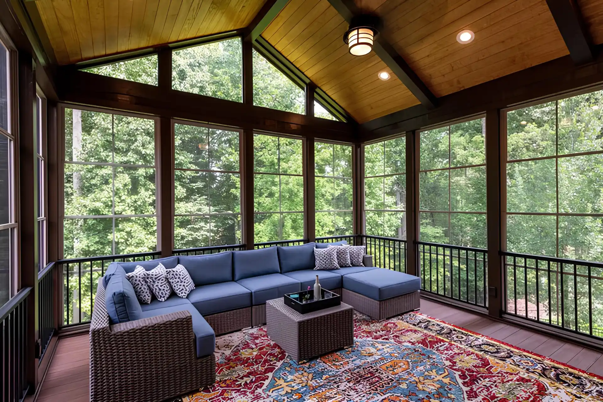 New modern 3 season room with furniture and overlooking trees on the background in worcester ma