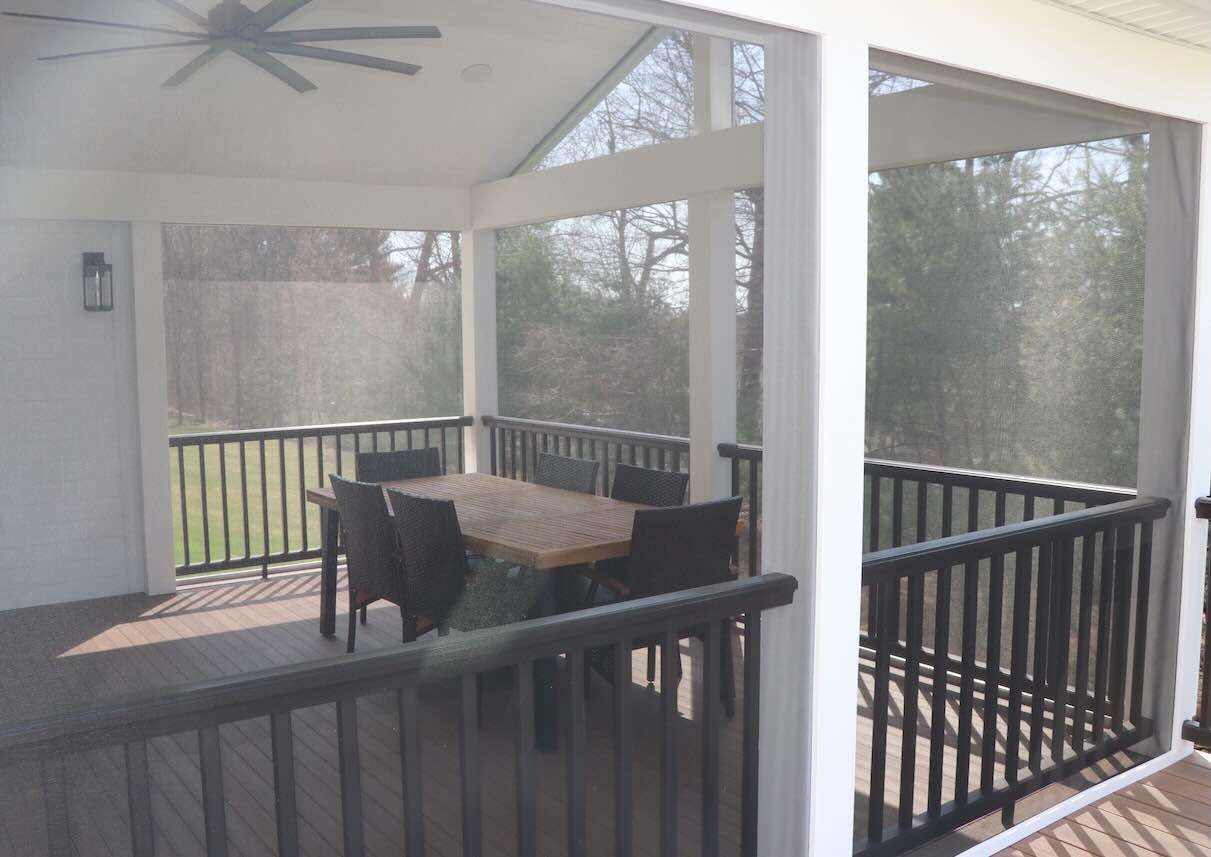 screened-in-porch-with-black-metal-railing-and-furnitures-in-worcester-ma.jpg