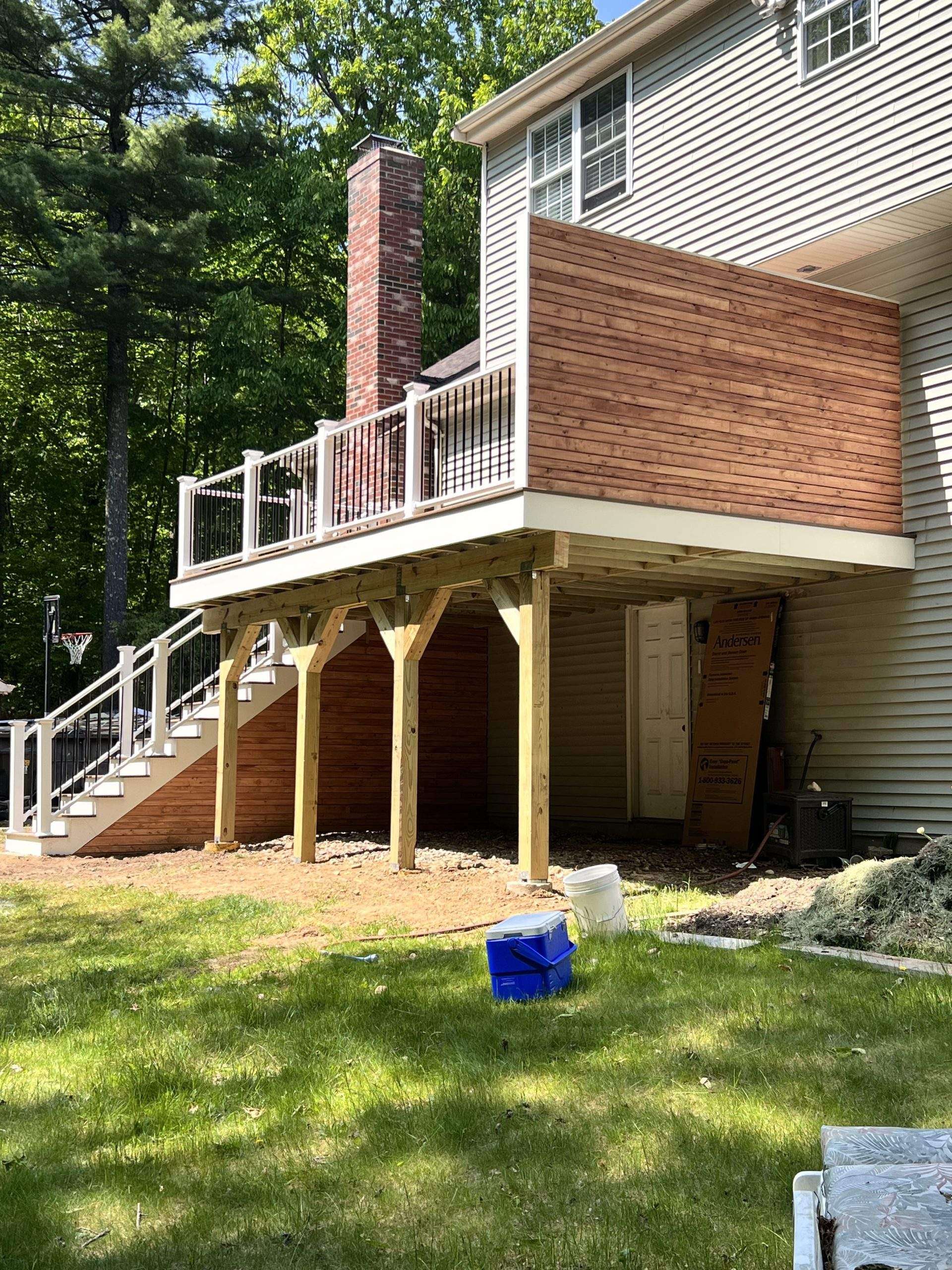 Under deck with black railing and privacy wall screen in worcester ma