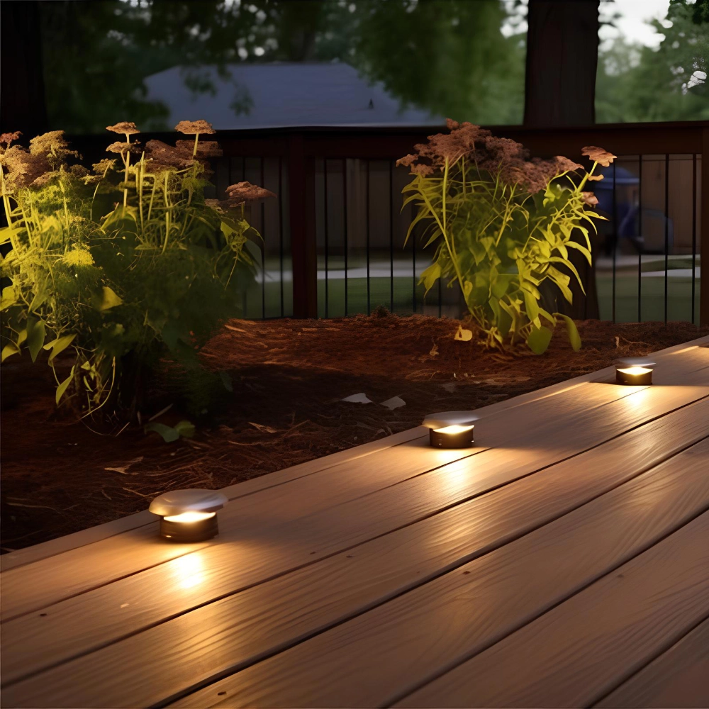 Wood deck lights zoomed in view with plants beside and black aluminum railing in worcester ma